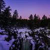 The moon setting over the frozen falls.