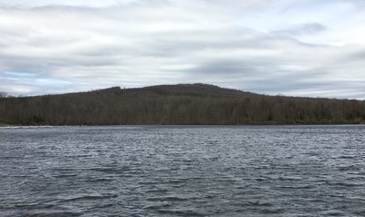 Haycock Mountain as viewed from the shore of<br>
Lake Nockamixon. A majestic peak it is not, but<br>
its wooded slopes hide hundreds of big, quality boulders.