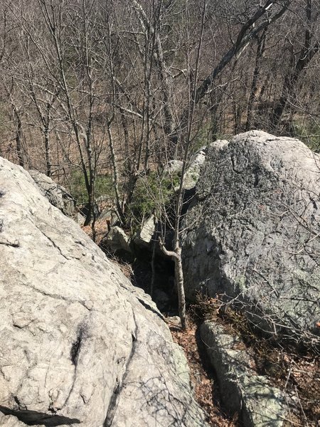 A view of Baby Roof Boulder area looking southeast from the flat hilltop. The Slab (V-Easy) and Hold Onto Sunshine (V5) are easily accessed from this crack.