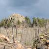 Black Dog Rock from the road. The approach is up the draw in the foreground.