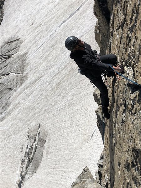 Middle Finger. Red colored, right angling 5.10 hand crack with overhang, easily seen from the ranger hut at the lower saddle makes the second lead above the ramp.