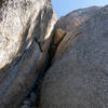 Chasm between the lower and upper buttresses. There's an anchor on top of the chock stones with cool looking routes above it. Not sure of the best way to get there. Unknown 5.10 on the right of photo.