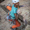 Sasha transitioning around the arete to the face halfway up the climb