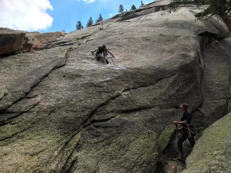 beginning the hike up the excellent first friction pitch - also a decent idea of where this route starts (left end of the dome).