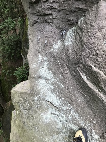 The hanging belay anchor on the left. This hidden anchor is rarely used.