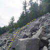 Looking up along the Slant Boulder field.
<br>

<br>
A 30-40 foot pine tree sits below the upper edge of the boulder field.  Turn up just north of this pine tree, and the Tower is just up into the trees.  From below another pedestal of rock is seen.