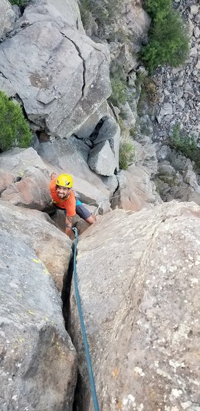 TJ Aguilar starting the final headwall crack. This is the cherry on top of this climb. The tooth can be seen below him as well as the top of the Shield.