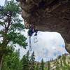 Cole Pazar aiding through Headline (C1). The right crack of the "Old Aid Roof" with two bolts is also known as "Deadline" after it was free-climbed by Rob or Jerry. The left crack is now known as "Headline" as the free climb of it will make headlines.