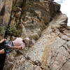 A climber on lead just below the second bolt.