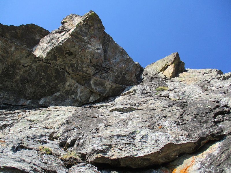 The final pitch (5.9 crux) goes through the black dihedral in the "V' just right of center.