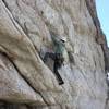 Peter Tsongalis working out the crux roof. It doesn't look like it but there are huge jugs just to the right and above him through the roof.