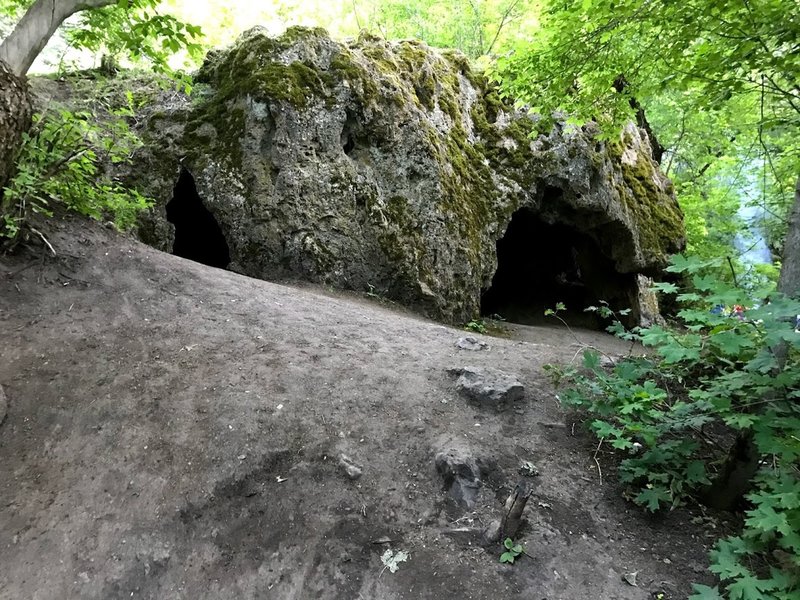 The caves are just across the stream.  The crag is just uphill a bit behind the caves.