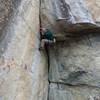 Climber (Dominic? if my memory is correct) pulling through the roof. 
<br>

<br>
This is similar to all the other pictures of people pulling the roof, but I'm posting this in case the climber sees it and wants the picture. Busy day at Crack in the Woods!