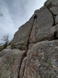 A climber on Becker, the top of Taco Filling in the upper right.