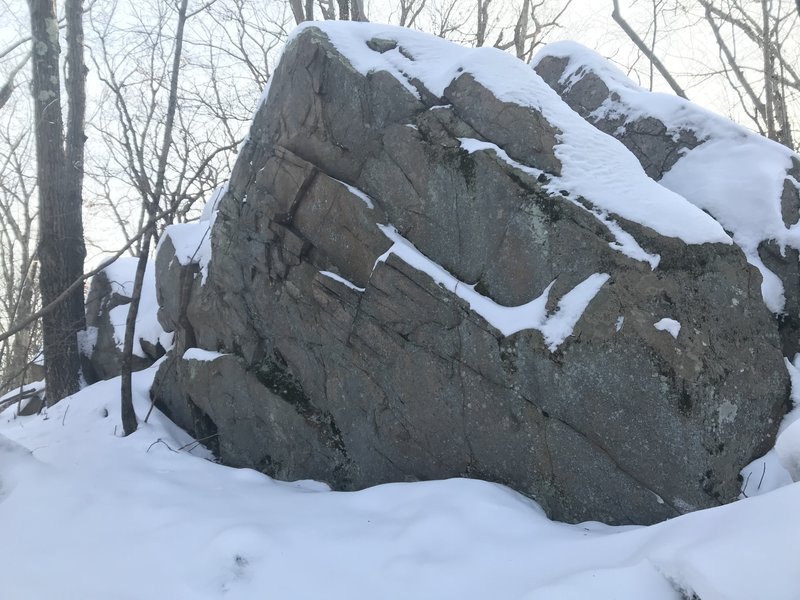 A slightly overhung boulder, it looks like it could have a few easy routes on it.