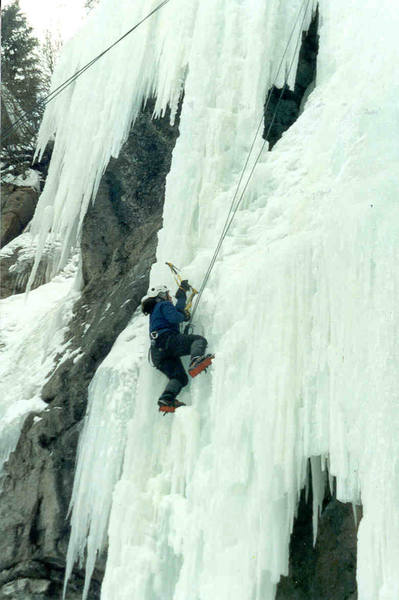 Climber hooking her way up to pillar.