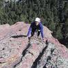 Warren Teissier enjoying sun and perfect rock on the second pitch of the SE Arete on the Second Flatiron.