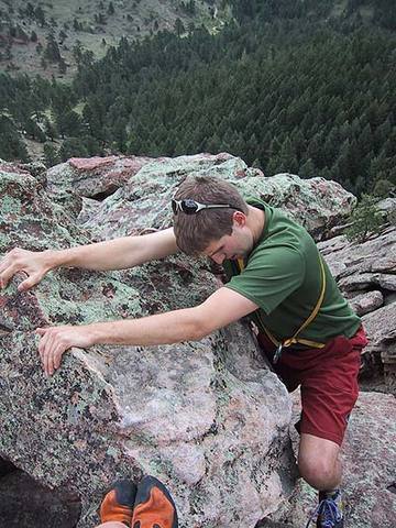 Myke Komarnitsky cranks the final moves onto the summit of the Front Porch.