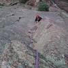 Looking down as Todd Pett solves the crux sequence on Casual Corner.