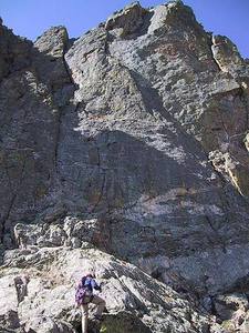 Scrambling up the easy middle ledge, finish alternatives visible above.