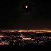 Moon rising over Boulder from the east face of the Third Flatiron.