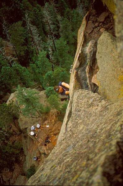 Peter Spindoe fighting the crux roof on the second pitch of the West Face of the 3rd Flatiron. Photo by Tony Bubb.