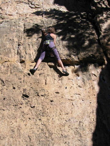 Halfling Beta: First, undercling, with the right hand in the big pocket. Second, get your feet way up, probably above the good holds used by all those dorky tall people.  Next, throw with the left hand for an awful edge that gets you into one of those all-streched-out-with-no-place-to-go stances.  Finally, match hands and scurry your furry little toes up so you can move through to better holds.  Hobbit, 5.10+. 