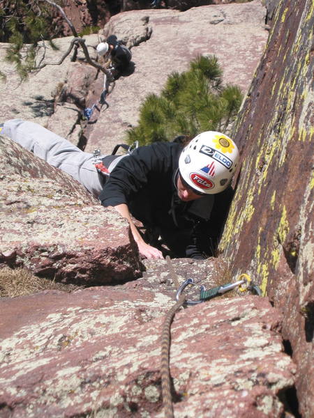 Fran stems up the crux right-facing dihedral of pitch 2.