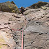 Mike looks down from the crux overhung section of pitch 2.