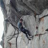 Starting up the overhanging final crux of Jolt. 