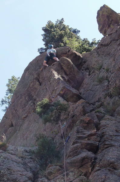 Ron Olsen climbing the crack at the final headwall.<br>
Photo by Mike Amato.