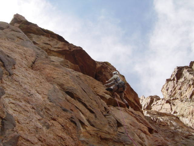 Jason (hardman) Keith approaching the first roof on the upper 10+ crack pitch of southern arete.  9/6/03 Matt Steward 