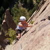 Marga Powell jamming the final crack to the summit.  Rebuffat's Arete looms in the background.