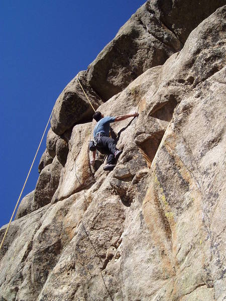 Chuck Graves starting the crux bulge. The crack to his left is very rounded. The crux of Rage Against the Machine climbs the ceiling at the two parallel cracks on the right at the top of the photo. Take the Power Back (5.9) passes the ceilings on the left where the belay end of the rope is.