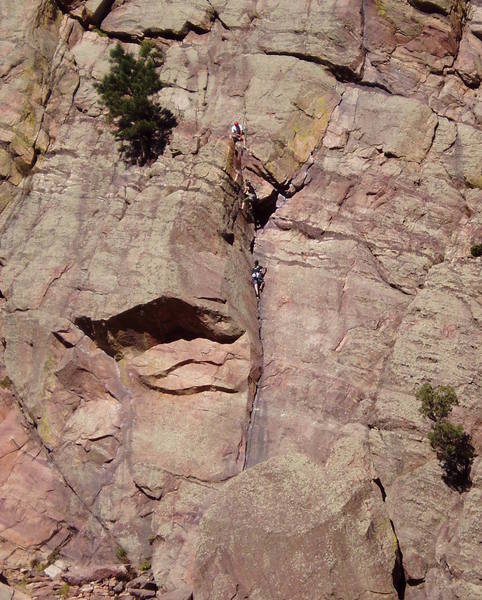 A climber turning the 5.8 roof of Calypso Direct with another party below on regular Calypso.