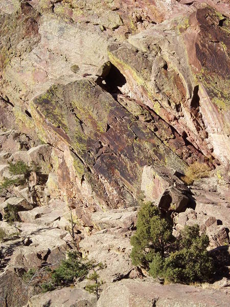 From the road it's pretty obvious. The route diagonals right past the black triangular recess in the center of the photo. The start angles left across the light pink band of rock. The Allosaur 5.7 "slab" is the light area at the top left of the photo.