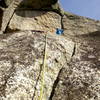 Follow the groove up to the fist crack (crux) where you can set up an anchor on a nice belay ledge