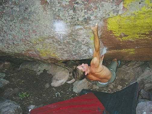 JJ landing the crux first move and sending Face Full of Brian, by Chip Phillips.