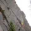 Cheating a bit (or am I?) approaching the first crux. Chuck Graves belaying. Paul Rezucha photograher.