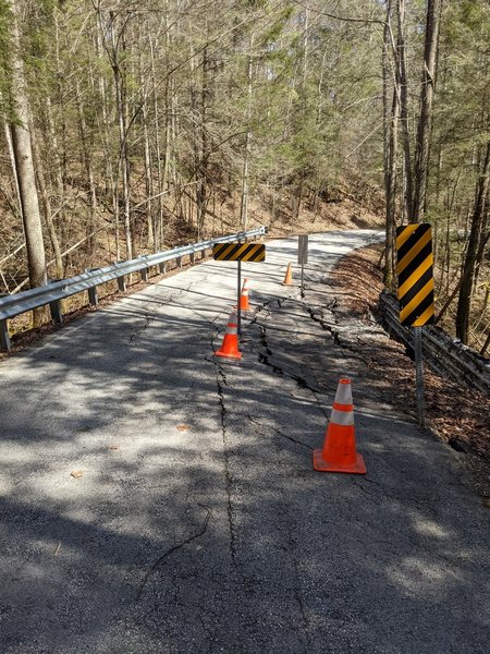 Kentucky 715 is blocked at the top of the hill. It's an additional 0.7 mile hike to get down but it's paved at least. It is closed starting at 37.810005,-83.590139 and you would need to park at the scenic overlook a bit north of this.