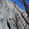 I'm posting this photo to show the nearby climbs, not Chuck's climbing prowess.<br>
<br>
The wide crack system right of Chuck is Sports Pages, 5.8. The next crack left of Chuck is Living Dead 11b. The crux of Living Dead ends at the pink belay ledge up and a bit left of Chuck. The 10a second pitch of Living Dead continues up the same crack system. The short left-facing corner further left is Dead Boy 10b. Dead Boy traverse right to Living Dead below the bulging orange rock. Dead Boy Direct 11d continues up the Dead Boy crack system left of the orange bulge. Flaked Out 5.9 climbs flakes and cracks at the far left of the photo and traverses right near the top of the photo.