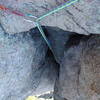 Looking down into the bowels of the chimney from the belay.