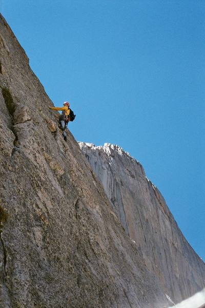 Errett is just past the second face traverse on the first pitch, with the Diamond in the background. You can see a biner clipped to the old rusty bolt about 6-8 feet left of his feet.