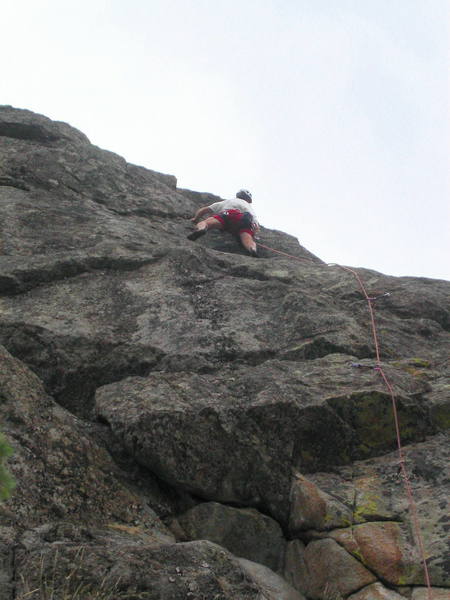 Peter Dillon at the crux move around the arete at the 8th bolt.