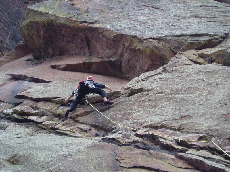 The gear is tenuous on this 5.6 traverse until you get to the downward pointing flake where you can bury a #3 Camalot (or place any of a number of smaller pieces). The route cuts back hard right around the roof on the right to the same crux crack for The Flakes and Whistle Stop. Photo by Ivan Rezucha.