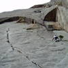 Fat City Crack climbs the rounded crack left of Chuck and then a think crack (10a?) above, traverses left to the wide crack and over the arching roof (10 b/c harder than it looks). High Plains Drifter continues up the slab above. Howling in the Wind climbs the wide crack in the large corner right of Chuck at 5.9 and then moves left at the large triangular overhang into the left facing corner. The thin cracks right of Howling in the Wind are the top of El Camino Real and Corner Pump Station.