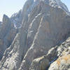 Another view of the north pillar from the NE. The pillar is the steep, sustained ramp with the sun hitting the arete of the ramp.