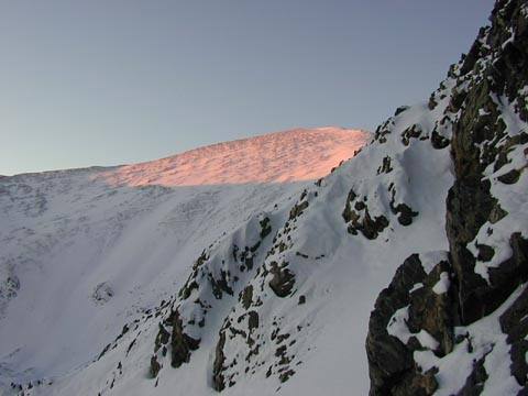 Morning sun rays hitting Grays Peak as viewed from the lower third of Dead Dog Couloir.