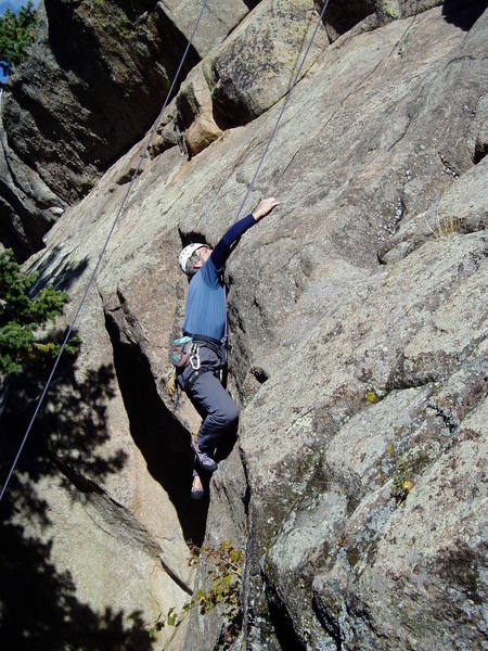 Reaching the good hold on the slab above the initial headwall.<br>
<br>
Photo by Paul Rezucha.