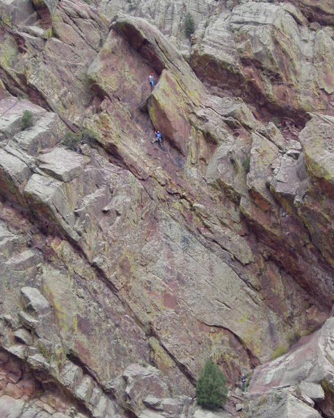 The second is approaching the crux of P2. The P3 crux is at the left end of the slanting overhang above the top climber. Thee somewhat runout 5.7 slab of P1 angles slightly left from the tree at the bottom of the photo. Another climber is just right of the tree.